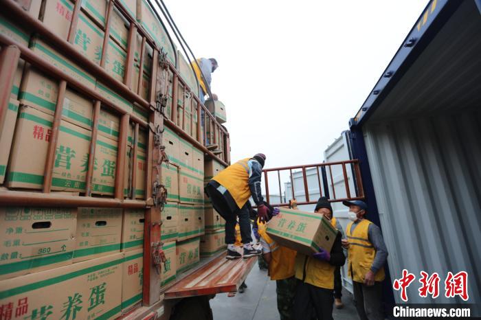 圖為鐵路裝卸作業(yè)人員正在將云南特色農產品裝入集裝箱。　楊航 攝
