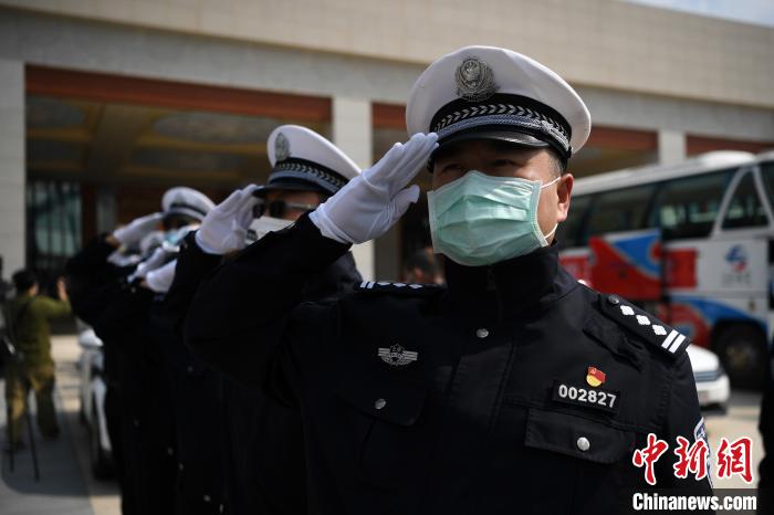圖為交警們向醫(yī)療隊(duì)敬禮?！】灯?攝