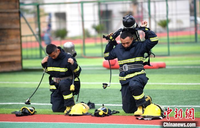 新消防員進(jìn)行穿戴空呼器展示。　劉忠俊 攝